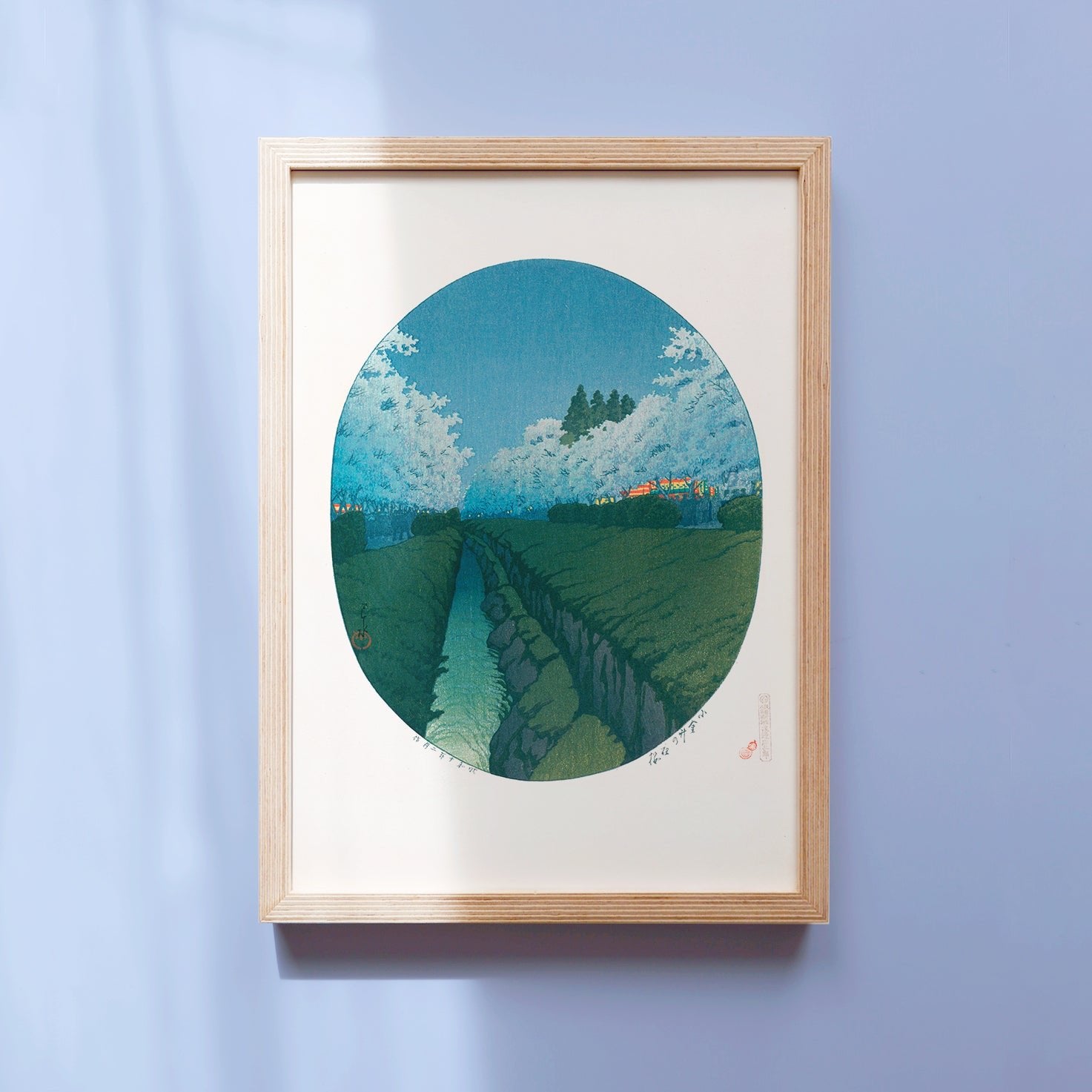 Framed Kawase Hasui's Japanese art poster featuring Night cherry blossoms in full bloom along the river