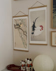 Rooster and Hen – Ohara Koson art print 30 x 60 cm on a wooden poster hanger in an interior