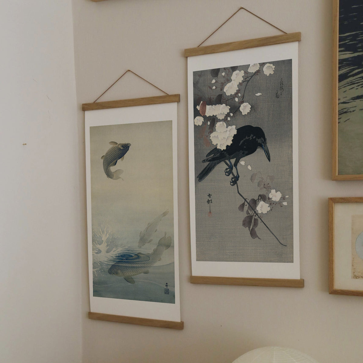 Crow on a cherry branch – Ohara Koson art print 30 x 60 cm on a wooden poster hanger in an interior
