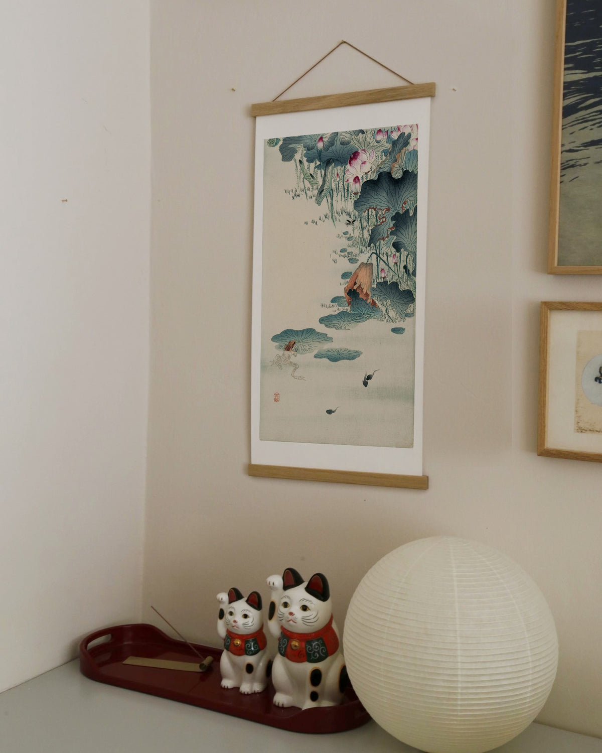 Frog and tadpoles – Ohara Koson art print 30 x 60 cm on a wooden poster hanger in an interior
