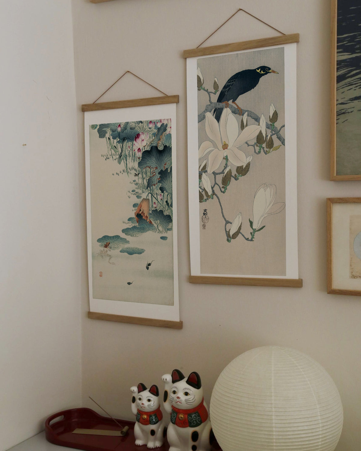 Myna on Magnolia Branch – Ohara Koson art print 30 x 60 cm on a wooden poster hanger in an interior