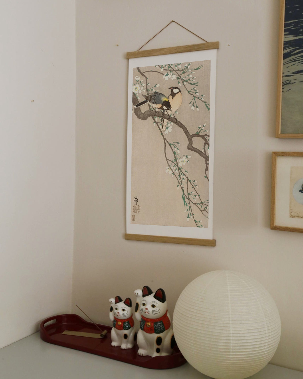 Tits on Cherry Branch – Ohara Koson art print 30 x 60 cm on a wooden poster hanger in an interior