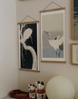 Two cranes – Ohara Koson art print 30 x 60 cm on a wooden poster hanger in an interior