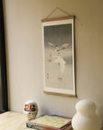 Two pigeons with falling ginko leaves – Ohara Koson art print 30 x 60 cm on a wooden poster hanger in an interior