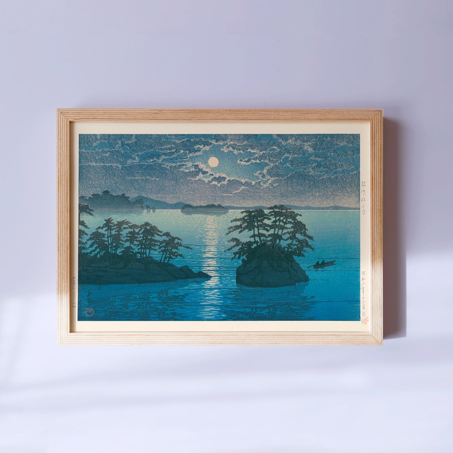 Framed Japanese Art Poster by Kawase Hasui, featuring a serene moonlit night with small islands on the sea