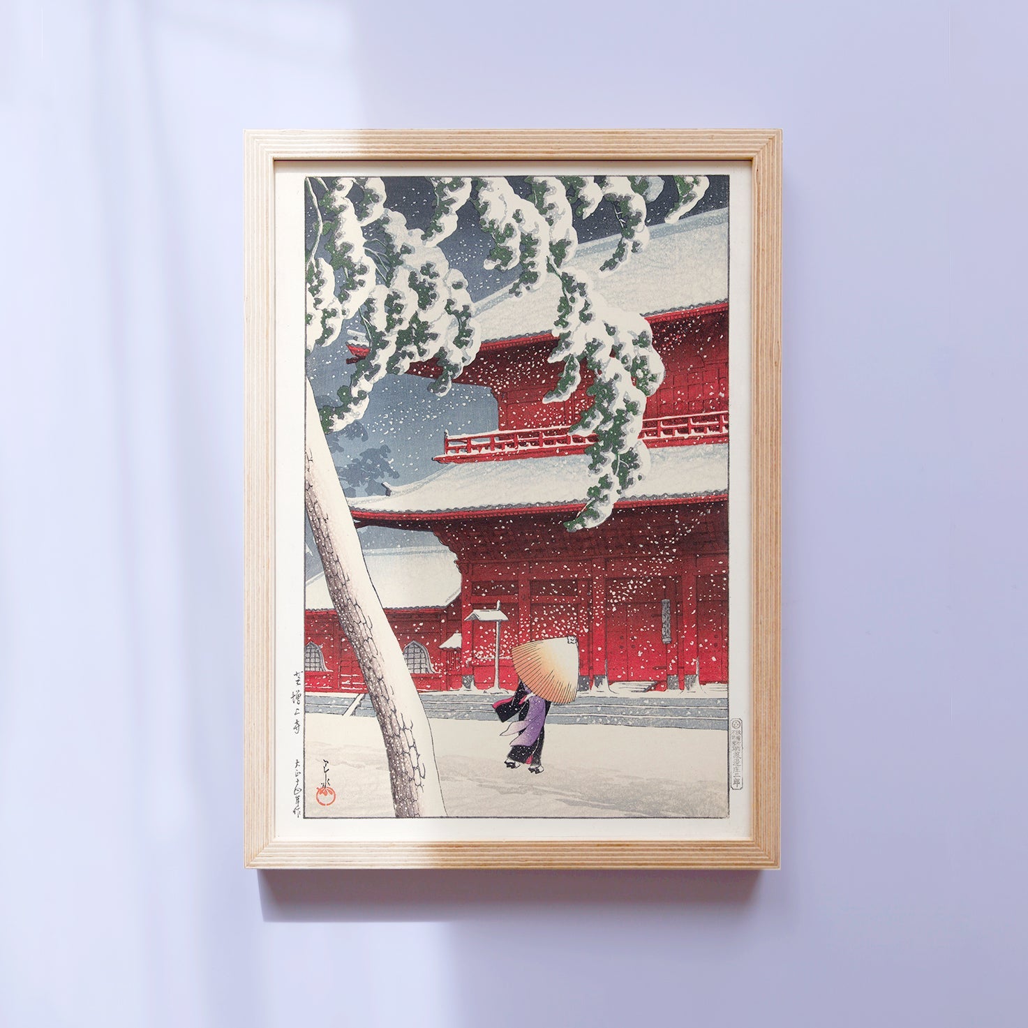 Framed Japanese Art Poster by Kawase Hasui, depicting a woman walking in the snowstorm with an umbrella.